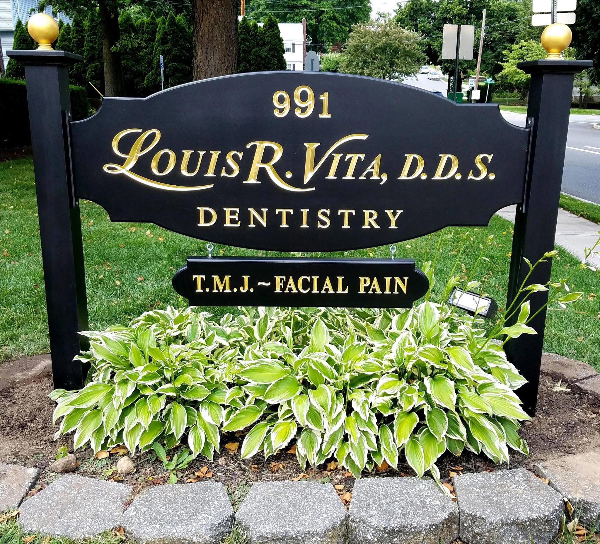 The image shows a sign with the name 'Louis Vita DDS' on it, indicating a dental practice.